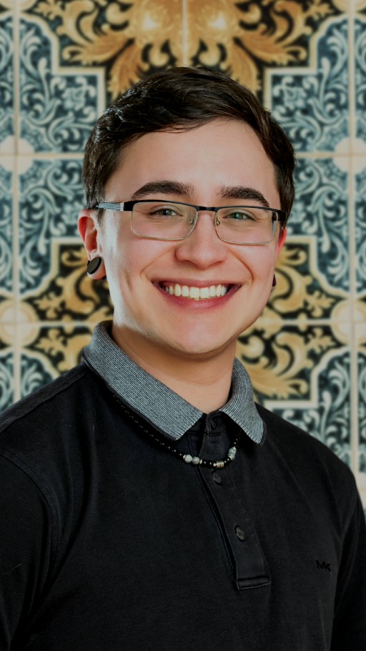 photo of roman sotomayor wearing glasses and smiling